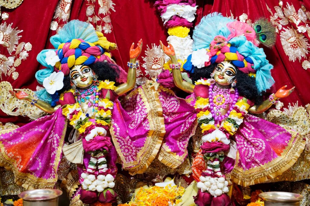 Colorful deities adorned in traditional attire at ISKCON Dhaka Temple, Bangladesh.